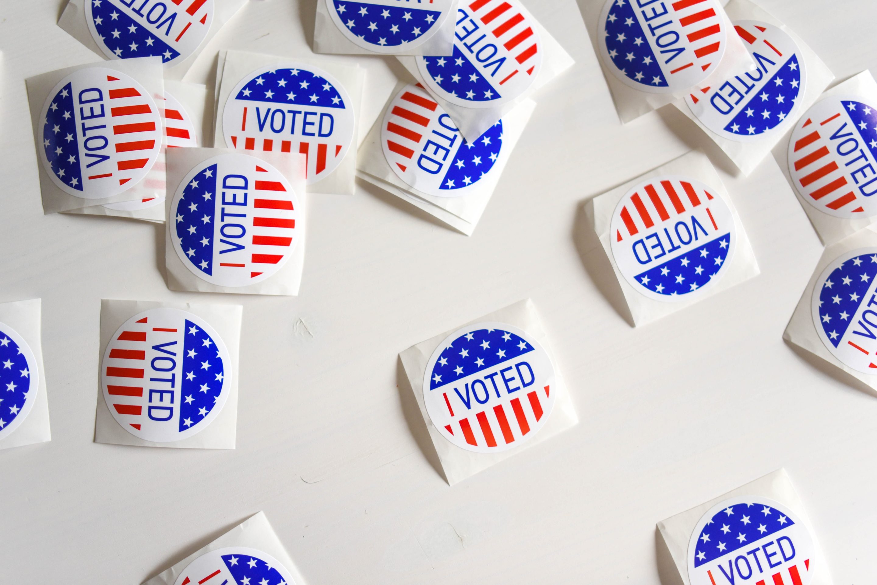 "I Voted" stickers scattered on a white table.